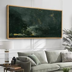 a living room filled with furniture and a large painting hanging on the wall above it