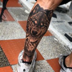 a man with a wolf tattoo on his leg