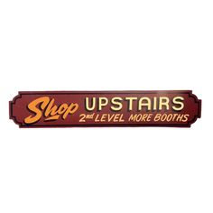 a sign that says, shop upstairss and level more booths on it's side