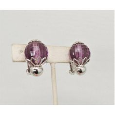 This is part of Chairish’s Costume Jewelry assortment.  Circa 1960 rhodium plated faceted disco ball-like faux-amethyst clip back earrings. Marked "Napier." Measure: 1 1/16 inches long by 13/16 inches wide. Condtion: Very good; a tiny amount of wear only noticeable upon very close inspection.  Please reference the measurements noted in the description above for the best approximate dimensions. Please reach out to the seller under "Ask the Seller" for specific questions regarding the measurements Formal Purple Clip-on Jewelry, Elegant Purple Clip-on Earrings For Formal Occasions, Purple Clip-on Earrings, Purple Clip-on Earrings For Formal Occasions, Modern Branding, Accessories Jewelry Earrings, Disco Ball, Clip Earrings, Vintage Signs