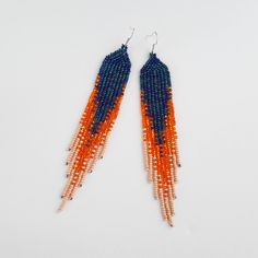 The best Christmas gift - handmade boho style earrings, long seed beaded earrings, shoulder dusters, best christmas gift My beaded items are lovingly handcrafted. Feminine and sophisticated enough to be worn as part of a classic casual or smart dress code and those special occasion surprises. Versatile for day and evening ensembles. ⚜️ Сompletely handmade! ⚜️ Combination of 3 colors - Navy blue, sparkling orange, matte orange ⚜️ Material - Czech Beads ⚜️ Style - Pierced ⚜️ Length -13 cm/5.12 inc Handwoven Orange Beaded Earrings For Gift, Handwoven Orange Beaded Earrings As Gift, Handmade Orange Long Drop Earrings, Orange Beaded Fringe Dangle Earrings, Orange Handwoven Dangle Beaded Earrings, Orange Bohemian Tassel Earrings With Dangling Beads, Dangle Beaded Earrings With Fringe For Crafting, Adjustable Orange Beaded Fringe Earrings, Bohemian Orange Beaded Earrings For Gifts