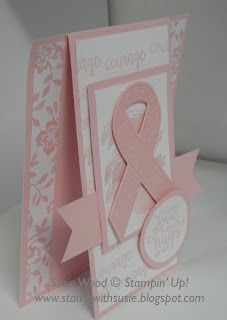 a card with a pink ribbon on it