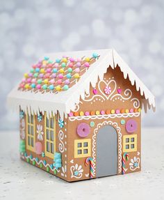 a gingerbread house is decorated with sprinkles