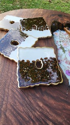 a wooden table topped with lots of different pieces of glass on top of each other