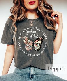 a woman wearing a t - shirt with a butterfly on it