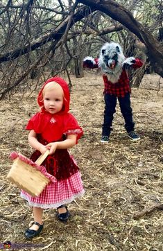 two children dressed up in costumes, one is holding a bag and the other has a puppet