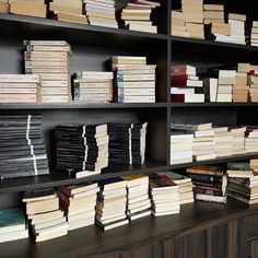 many books are stacked up on the shelves