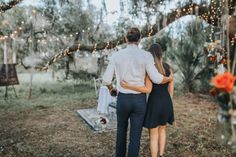 a man and woman walking away from the camera