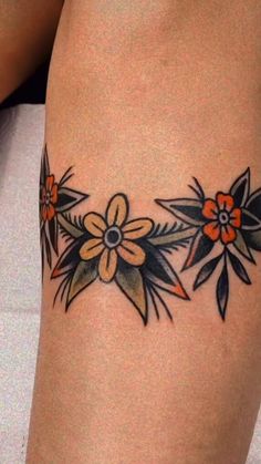 a woman's thigh with flowers on it