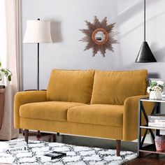 a living room with a yellow couch and white rug