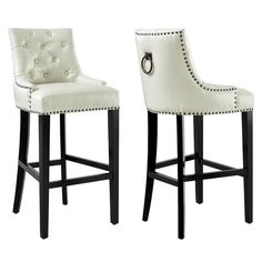 two white barstools with black legs and studded trimmings on them