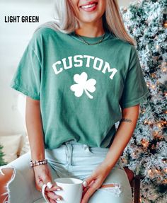 "Comfort Colors Custom Shamrock Shirt, Personalized Last Name St Patrick's Day Shirt, Irish Lucky Tee, St Patrick's Day Women, St Patty's Gift Thank you for shopping with us❤️ Size - Our products are unisex fit - You can check our size and color charts on our listing photos. How To Order - Select a size - Select a t-shirt color - If available, indicate the design (text) color in the personalization box - Click add to cart. You can go back to add more shirts. - Click \"Proceed to check out\". Care Instruction -Machine wash in cold water -Do not use bleach -Tumble dry low -Inside out, wash with delicate cycle -Do not iron directly over design Production and Shipping - Processing is 1-3 days * Shipping Time is depending on the shipping option that you choose during to checkout process - Pleas St. Patrick's Day Graphic Print Crew Neck Top, St. Patrick's Day Cotton Crew Neck Tops, Cute Green Crew Neck Shirt, Customizable Green Short Sleeve T-shirt, Cotton Crew Neck Top For St. Patrick's Day, Customizable Green Cotton Tops, Cute Green T-shirt With Custom Print, Casual Pre-shrunk T-shirt For St. Patrick's Day, Casual Green T-shirt For St. Patrick's Day