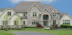 a large house with lots of windows and landscaping