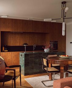 a kitchen and dining room with wood paneling