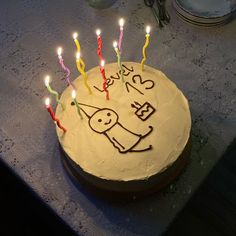 a birthday cake with lit candles on it