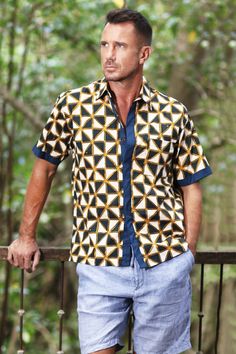 In tones of ivory amber and navy bold geometric patterns are printed onto this men's cotton shirt from Bali. The motifs are applied using the batik method where a wax resist is stamped by hand onto the fabric before it is dyed. Hari and Arthur design this casual accessory featuring a collar short sleeves and a button-up front. Relaxed Fit Shirt With Batik Print, Batik Art, Batik Design, Wax Resist, Cotton Shirts For Men, Casual Accessories, Dressy Casual, Shirt And Pants, Geometric Patterns