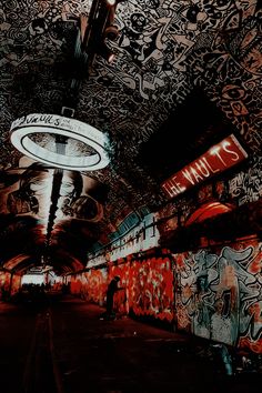 graffiti covered walls and ceilings in an underground subway station