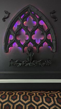 a decorative wall decoration with purple lights on it