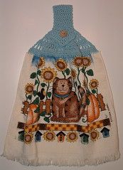 this is an image of a bear and pumpkins on a tablecloth hanging from the wall