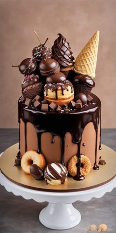 a chocolate cake with ice cream and donuts on top