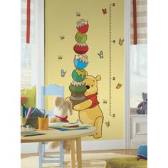 a winnie the pooh growth chart wall decal in a child's room