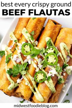 a white plate topped with tacos covered in guacamole and cilantro