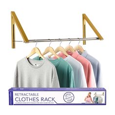 a rack with clothes hanging on it next to a woman