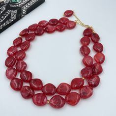 Make a bold statement at your next special event with our Vibrant Sangria Red Chunky Necklace. This double strand statement piece is perfect for weddings or any festive occasion, featuring rich, sangria red beads that add a splash of color and elegance. Each necklace is carefully handcrafted, making it a unique and stunning addition to your jewelry collection. - Necklace length is 17" shortest strand plus additional 3 inch extender chain for length adjustment. Matching earrings are available. Se Acrylic Clouds, Short Layer, Sangria Red, Long Layer, Red Beaded Necklaces, Red Sangria, Autumn Necklace, Christmas Necklace, Red Beads