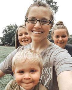 a woman and two children taking a selfie