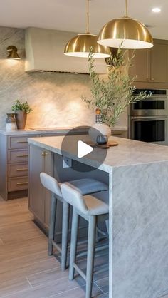 a kitchen with marble counter tops and stools next to an island in the middle