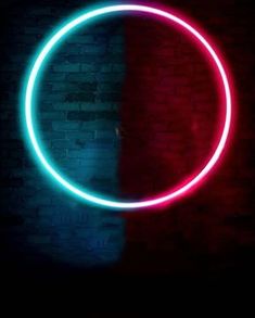 a red and blue neon circle on a brick wall