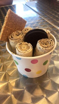 a bowl filled with cookies and crackers on top of a table