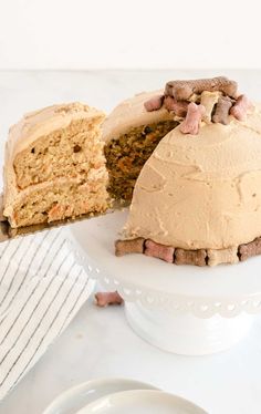 a cake that has been cut in half and is sitting on a plate with one slice taken out