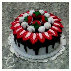 a decorated cake with chocolate icing and strawberries on top