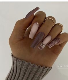 a woman's hand with long, shiny nails and rings on her fingers is shown