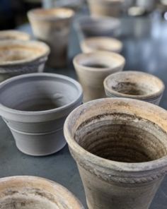 several clay pots lined up on a table