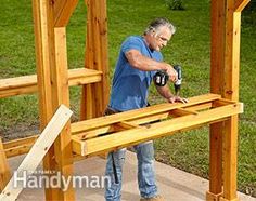 a man using a power drill to build a wooden structure