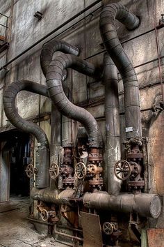 an old industrial building with pipes and machinery