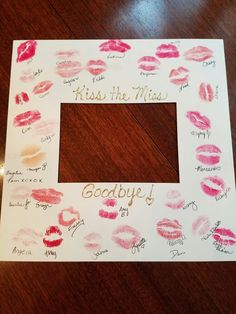 a photo frame with lipstick drawn on it and the words kiss the miss goodbye written in gold