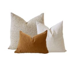 three pillows with different colors and sizes on white background, one in brown, the other in beige