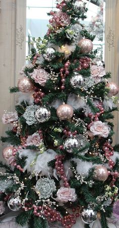 a decorated christmas tree with pink and silver ornaments