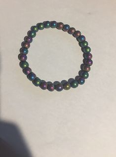 "Colorful Rainbow Hematite Gemstone Stretch Beaded Bracelet 8 mm Matte or Shiny and 7.5\" or 8\" They stretch with the elastic. Rainbow Hematite Hematite is an iron oxide mineral which occurs in most metamorphic and sedimentary rocks. Hematite often occurs intermixed with Quartz. ... Hematite intermixed with Goethite is also known as Rainbow Hematite and is wonderfully iridescent. Hematite has very strong grounding energy; you can feel that just by holding the stone in your hand. It also has a c Iridescent 8mm Round Bead Jewelry, Spiritual Iridescent Jewelry With 8mm Beads, Adjustable Iridescent Jewelry With 8mm Beads, Multicolor Pearl Bracelet With 8mm Round Beads, Hematite Stretch Bracelet With 8mm Beads, Beaded Hematite Bracelets, Iridescent Bracelets With Faceted Beads, Hematite Crystal Bracelet With 8mm Beads, 8mm Hematite Beads Jewelry