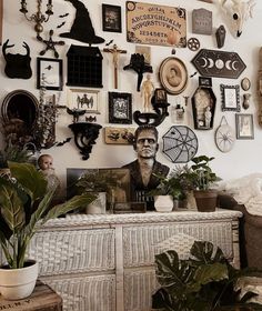 a room filled with lots of different types of items on the wall and plants in pots