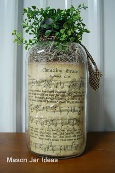 a jar with some plants in it on a table