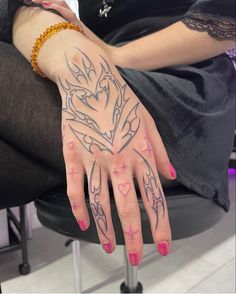 a woman's hand with tattoos on it