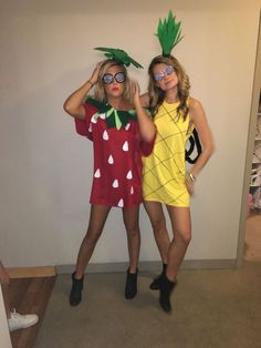 two women dressed in fruit costumes posing for the camera