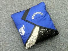 a blue bag with sequins on it sitting on the ground