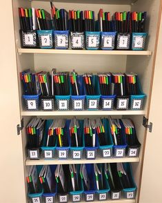 a book shelf filled with lots of different colored pens and pencils on top of each other