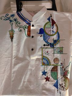 a white shirt with colorful designs on it