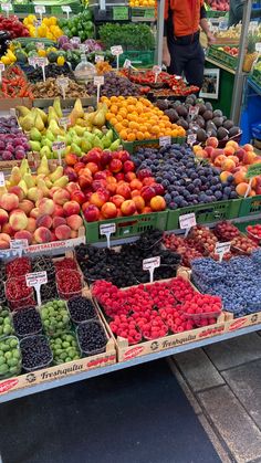 a fruit stand with lots of different types of fruits